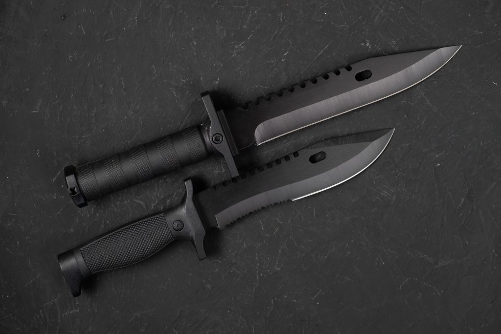 South Dakota knife laws - Tactical knives on a black surface.
